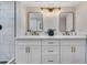 Modern bathroom with double vanity, quartz countertops, and decorative lighting fixtures at 5025 W New World Dr, Glendale, AZ 85302