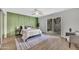 Serene bedroom with green accent wall, comfortable bed, and sliding glass doors to the outside at 5025 W New World Dr, Glendale, AZ 85302