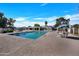 Community pool with plenty of lounge chairs and tables at 5025 W New World Dr, Glendale, AZ 85302