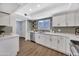 Updated kitchen with white cabinets, modern backsplash, stainless steel appliances and wood-look floors at 5025 W New World Dr, Glendale, AZ 85302