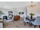 Open-concept living and dining area featuring modern decor, wood flooring, and ample natural light at 5025 W New World Dr, Glendale, AZ 85302