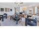 Spacious living room with stylish seating, wood-look flooring, and a view into the dining area at 5025 W New World Dr, Glendale, AZ 85302