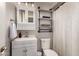 Modern bathroom with stylish vanity, toilet, and industrial shelving at 5031 W Grandview Rd, Glendale, AZ 85306