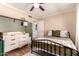 Bedroom with a black metal bed frame and a small green baby crib at 5031 W Grandview Rd, Glendale, AZ 85306