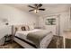 Comfortable bedroom with a queen bed, neutral decor, and a window overlooking a leafy yard at 5031 W Grandview Rd, Glendale, AZ 85306