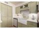 Stylish kitchen featuring a farmhouse sink, stainless steel appliances, and ample cabinet space at 5031 W Grandview Rd, Glendale, AZ 85306