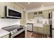 Updated kitchen with modern appliances, including stainless steel microwave and ceramic cooktop at 5031 W Grandview Rd, Glendale, AZ 85306