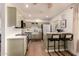 Charming kitchen with light green cabinets, farm sink, stainless steel appliances, and breakfast bar seating at 5031 W Grandview Rd, Glendale, AZ 85306