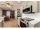Open-concept kitchen showcasing modern appliances and seamless flow to the dining area with ample natural light at 5031 W Grandview Rd, Glendale, AZ 85306