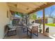Relaxing covered patio with comfortable seating, complemented by a landscaped backyard at 5031 W Grandview Rd, Glendale, AZ 85306