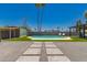 Stunning backyard featuring a pristine pool, lush artificial turf, and desert landscaping at 5031 W Grandview Rd, Glendale, AZ 85306