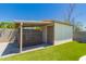 Backyard shed and storage area, enclosed with fencing and features an artificial turf ground cover at 5031 W Grandview Rd, Glendale, AZ 85306