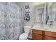 Clean bathroom featuring a patterned shower curtain, vanity, and modern lighting at 6235 S Odessa Dr, Gilbert, AZ 85298