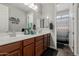 Well-lit bathroom with a double sink vanity, large mirror, and modern fixtures at 6235 S Odessa Dr, Gilbert, AZ 85298