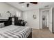 Neutral bedroom with a ceiling fan, study area, and ample natural light at 6235 S Odessa Dr, Gilbert, AZ 85298