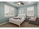 Tranquil bedroom featuring calming blue walls, bright windows, and inviting decor at 6235 S Odessa Dr, Gilbert, AZ 85298