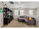 Stylish bonus room with sectional couch, mounted television, and shelving, ideal for entertaining at 6235 S Odessa Dr, Gilbert, AZ 85298