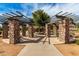 Community area featuring stone pillars, shaded benches, and a playground, creating a welcoming and engaging space at 6235 S Odessa Dr, Gilbert, AZ 85298