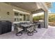 Covered patio with an outdoor dining area, a grill, and string lights; great for outdoor cooking and entertaining at 6235 S Odessa Dr, Gilbert, AZ 85298