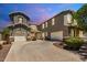 Stunning two-story home with dual garages, stone accents, and a charming tiled roof at 6235 S Odessa Dr, Gilbert, AZ 85298