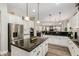 Well-equipped kitchen with a view into the living area, featuring stainless steel appliances and granite counters at 6235 S Odessa Dr, Gilbert, AZ 85298