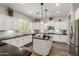Bright and spacious kitchen with white cabinets, granite countertops, and stainless steel appliances at 6235 S Odessa Dr, Gilbert, AZ 85298