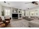 Cozy living room featuring a large TV, comfortable seating, and built-in shelving at 6235 S Odessa Dr, Gilbert, AZ 85298