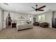 Spacious main bedroom boasts a decorative ceiling fan, large windows, and a comfortable seating area at 6235 S Odessa Dr, Gilbert, AZ 85298