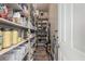 Walk-in pantry with lots of shelving, offering ample storage for all your kitchen needs at 6235 S Odessa Dr, Gilbert, AZ 85298