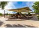 Shaded community playground with multiple slides and play areas for ' outdoor fun at 6235 S Odessa Dr, Gilbert, AZ 85298