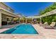 Backyard pool with lounge chairs, a pergola, an outdoor kitchen, and a covered patio perfect for entertaining at 6235 S Odessa Dr, Gilbert, AZ 85298