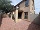 Spacious backyard with neutral toned stucco exterior and covered patio with large support beams at 6339 W Sophie Ln, Laveen, AZ 85339