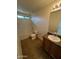 Bathroom with bath tub, toilet and single sink vanity with stone counter, framed mirror and lighting fixture at 6339 W Sophie Ln, Laveen, AZ 85339