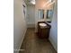 Bathroom with tiled floors, single sink vanity, mirror, toilet, shower, and tub combo at 6339 W Sophie Ln, Laveen, AZ 85339
