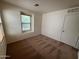 Empty bedroom with carpet, window with blinds, and a closet at 6339 W Sophie Ln, Laveen, AZ 85339