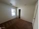 Empty bedroom with neutral carpet and a window with blinds at 6339 W Sophie Ln, Laveen, AZ 85339