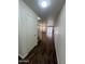 Entryway with dark vinyl floors leading to open-concept living area and staircase at 6339 W Sophie Ln, Laveen, AZ 85339