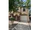 Inviting two-story home featuring a well-manicured lawn and a private two-car garage at 6339 W Sophie Ln, Laveen, AZ 85339