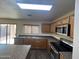 Eat-in kitchen featuring an island, stainless steel appliances, and an exterior access door at 6339 W Sophie Ln, Laveen, AZ 85339