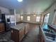 Spacious kitchen with stainless steel appliances opens to a dining area and living room at 6339 W Sophie Ln, Laveen, AZ 85339