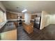 Modern kitchen with stainless steel appliances, a center island, and vinyl flooring at 6339 W Sophie Ln, Laveen, AZ 85339