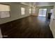 Spacious living room featuring vinyl floors, a ceiling fan, and sliding door access to the yard at 6339 W Sophie Ln, Laveen, AZ 85339