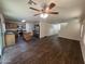 Open-concept living area flows to the kitchen with stainless steel appliances and island with counter seating at 6339 W Sophie Ln, Laveen, AZ 85339