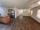 Spacious living room with wood floors opens to kitchen with stainless steel refrigerator and island at 6339 W Sophie Ln, Laveen, AZ 85339