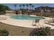 Community pool with lounge chairs and desert landscaping with various desert trees at 6339 W Sophie Ln, Laveen, AZ 85339