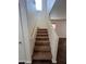 Carpeted staircase with handrail leads to upper level of home at 6339 W Sophie Ln, Laveen, AZ 85339