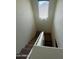 Carpeted staircase with white banister and a window allowing natural light into the home at 6339 W Sophie Ln, Laveen, AZ 85339