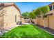 A spacious backyard features artificial grass, drought-resistant landscaping, and a fenced-in area at 6808 W Angela Dr, Glendale, AZ 85308