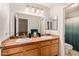 Bathroom with double sinks, large mirror, neutral colors, and toilet visible in frame at 6808 W Angela Dr, Glendale, AZ 85308