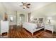 Bright bedroom features hardwood floors, neutral tones, and a ensuite bathroom that offers comfort and privacy at 6808 W Angela Dr, Glendale, AZ 85308